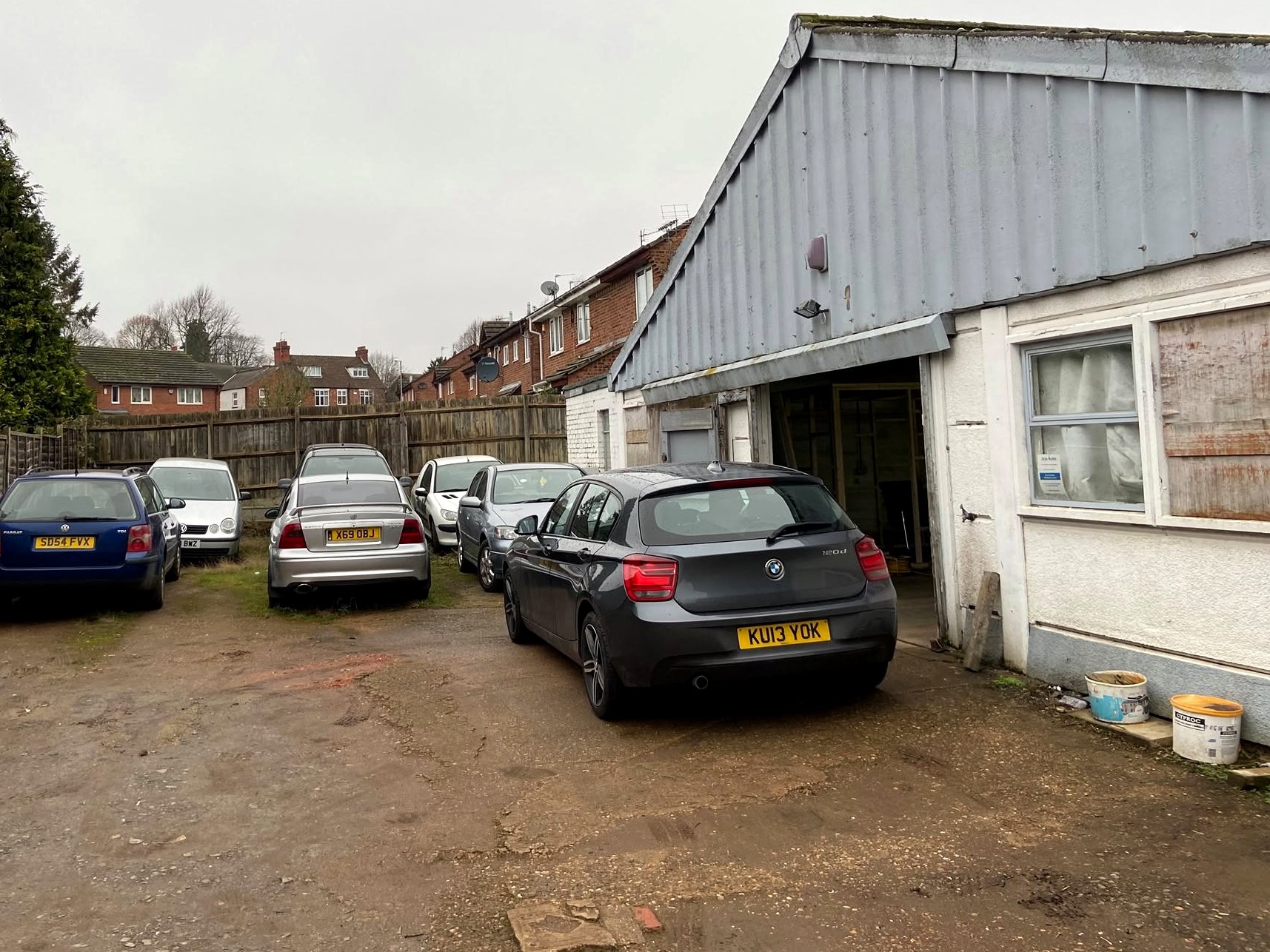 The yard at Adams Yard South with customers' cars outside Jays Autocentre's workshop
